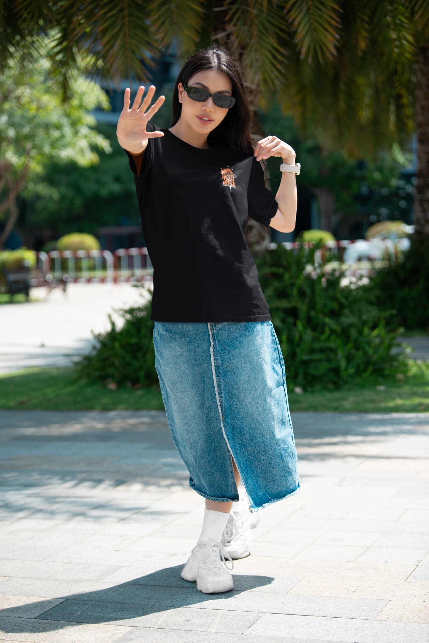 Model wearing black Ancient Wonders Tee, full front view with small chest graphic