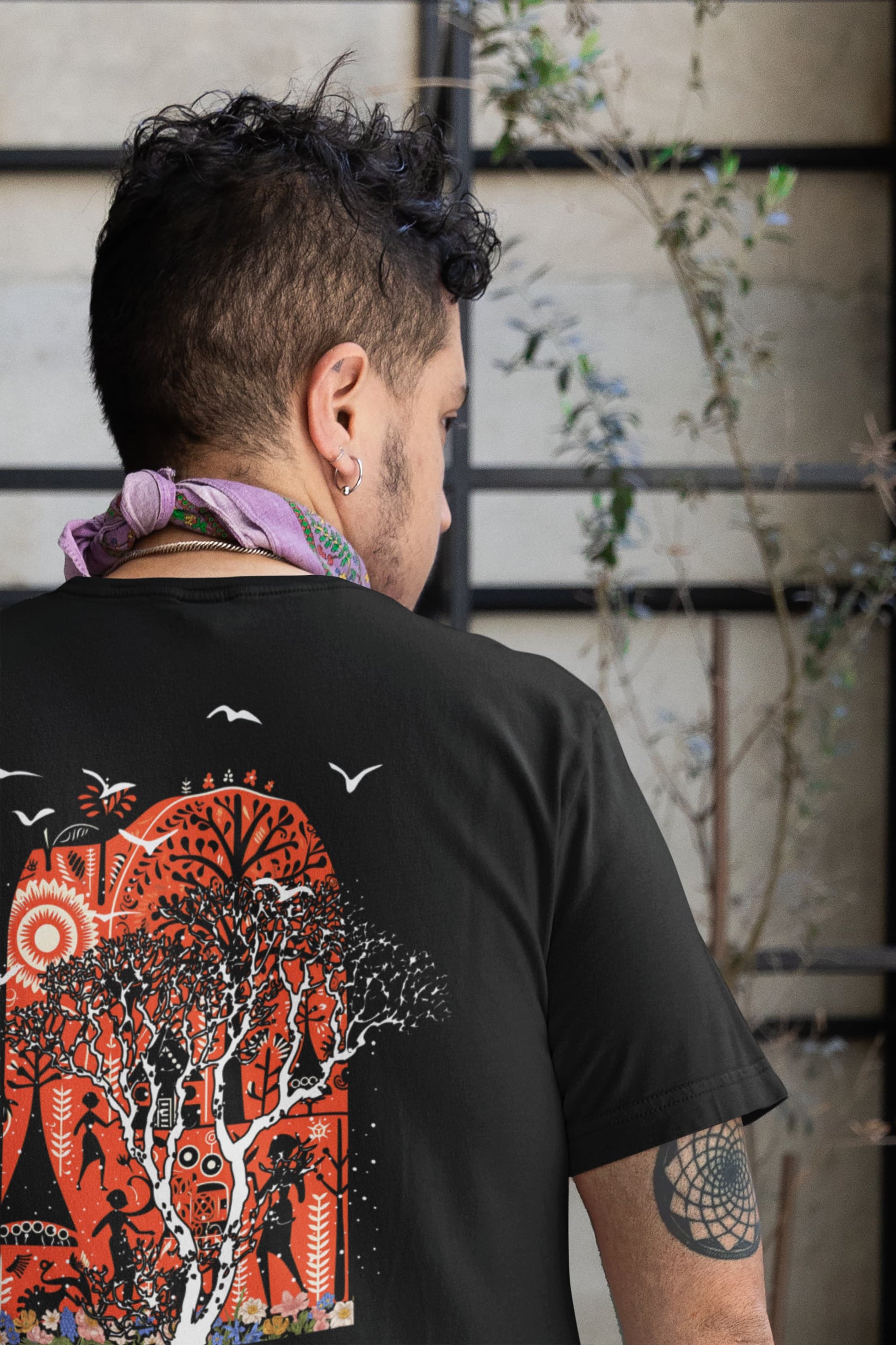 Lifestyle close-up of back graphic on Ancient Wonders Tee, detailed red and black artwork